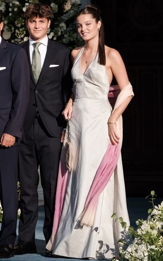 Amelia Morales wearing a light gray dress to a wedding