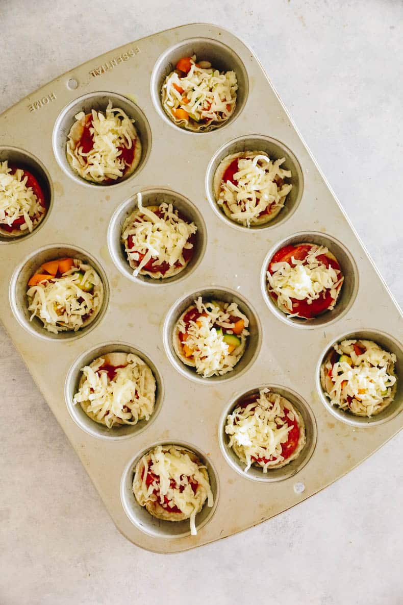 mini pizzas in a muffin tin.