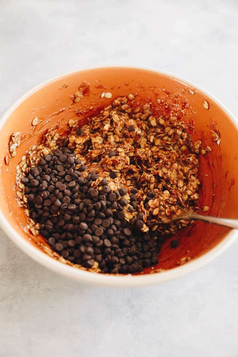 Vegan oatmeal cookie batter in an orange bowl.