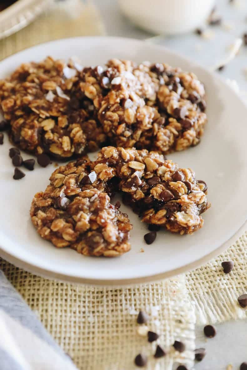 Up close image of vegan oatmeal cookies on a white plate.